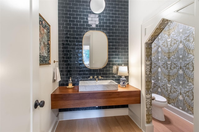 5620 Copper Park, Tyler, TX 75703 - half bathroom featuring toilet, wood finished floors, vanity, and baseboards
