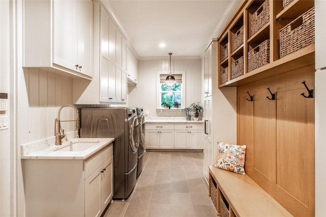 5620 Copper Park, Tyler, TX 75703 - washroom with cabinet space, washer and dryer, light tile patterned floors, and crown molding