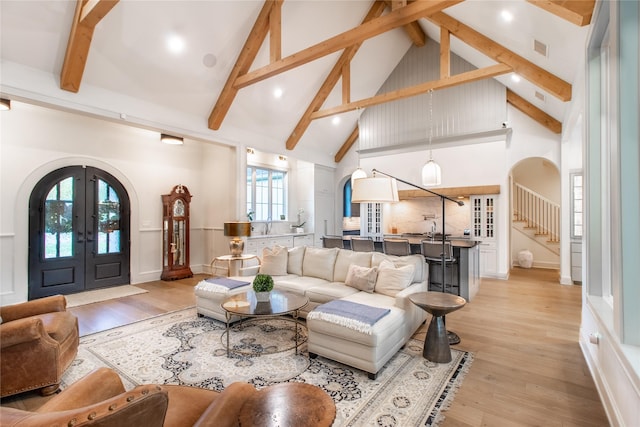 5620 Copper Park, Tyler, TX 75703 - living area with arched walkways, high vaulted ceiling, light wood-style flooring, beam ceiling, and french doors