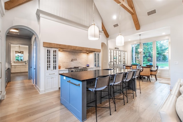 5620 Copper Park, Tyler, TX 75703 - kitchen with a sink, light wood-type flooring, high vaulted ceiling, beamed ceiling, and a breakfast bar area