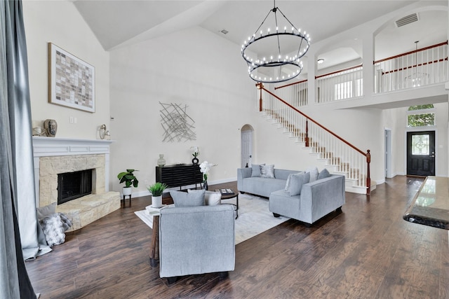 8620 Thistle Ridge Ter, Fort Worth, TX 76123 - living room with stairs, high vaulted ceiling, dark wood-style floors, a fireplace, and a chandelier