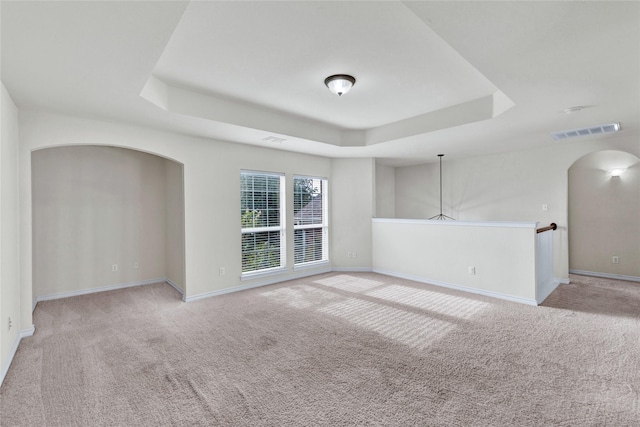 8620 Thistle Ridge Ter, Fort Worth, TX 76123 - unfurnished room featuring arched walkways, a raised ceiling, light carpet, and baseboards