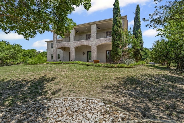 1424 Keeneland Hill Dr, Aledo, TX 76008 - back of property with a ceiling fan, a balcony, a yard, and stucco siding