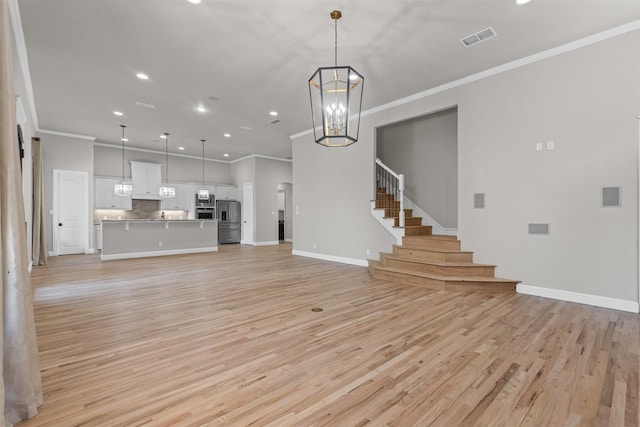 1424 Keeneland Hill Dr, Aledo, TX 76008 - unfurnished living room featuring ornamental molding, recessed lighting, light wood finished floors, a chandelier, and baseboards