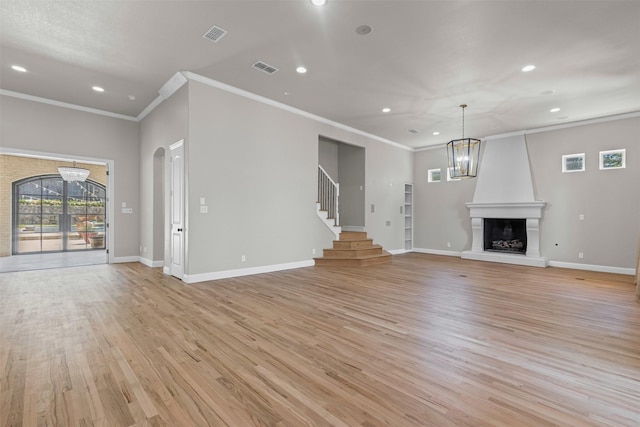 1424 Keeneland Hill Dr, Aledo, TX 76008 - unfurnished living room featuring crown molding, recessed lighting, light wood-style floors, a chandelier, and a fireplace