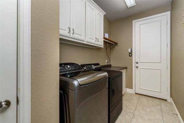 136 Whispering Winds Dr, Gunter, TX 75058 - laundry area with independent washer and dryer, cabinet space, light tile patterned floors, and baseboards