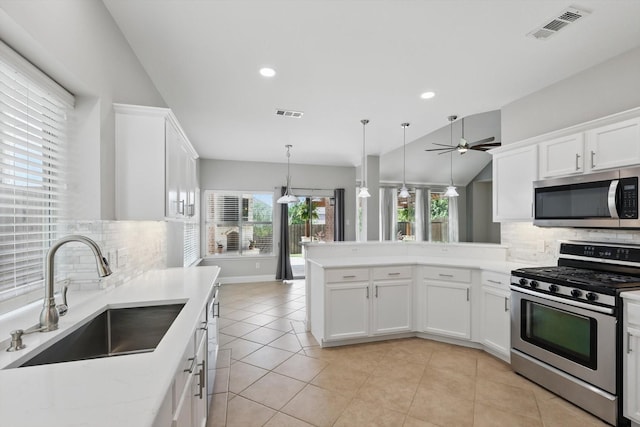 6808 Edgefield Dr, Denton, TX 76210 - kitchen with appliances with stainless steel finishes, a sink, decorative backsplash, white cabinetry, and recessed lighting
