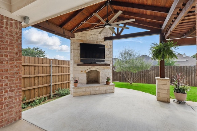 6808 Edgefield Dr, Denton, TX 76210 - fenced backyard featuring an outdoor stone fireplace, a patio, and ceiling fan