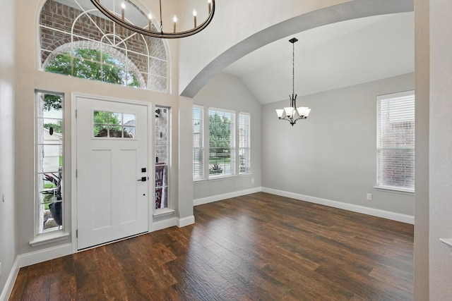 6808 Edgefield Dr, Denton, TX 76210 - foyer entrance with a chandelier, baseboards, wood finished floors, arched walkways, and lofted ceiling