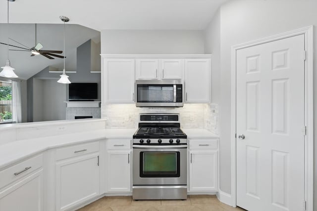 6808 Edgefield Dr, Denton, TX 76210 - kitchen featuring appliances with stainless steel finishes, ceiling fan, tasteful backsplash, light countertops, and white cabinetry