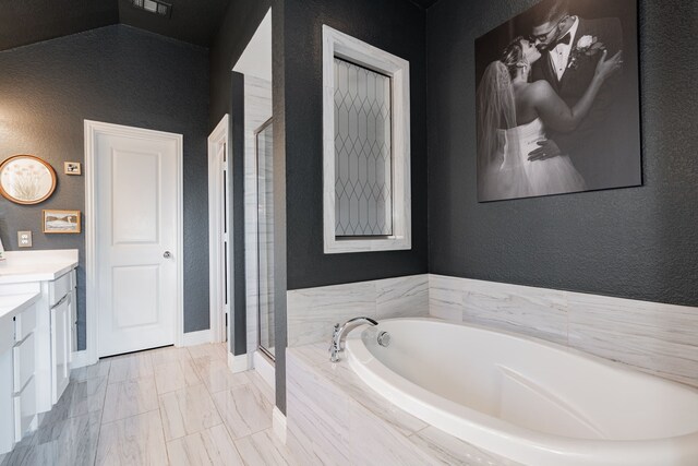 1406 Darlington Ln, Forney, TX 75126 - full bath with vanity, a textured wall, a shower stall, a garden tub, and baseboards
