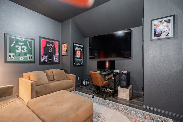1406 Darlington Ln, Forney, TX 75126 - home theater room featuring wood finished floors, a textured wall, vaulted ceiling, and baseboards