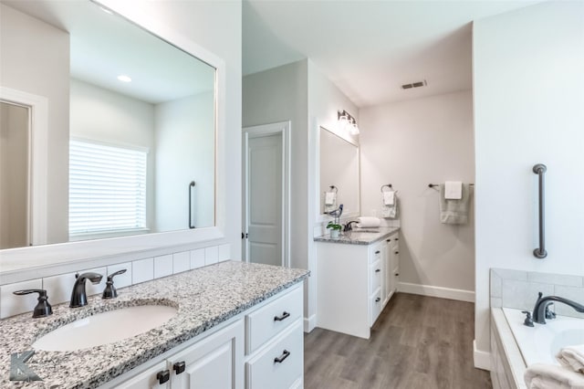 2326 Plymouth Rock Rd, Abilene, TX 79601 - full bath with vanity, a bath, wood finished floors, and baseboards