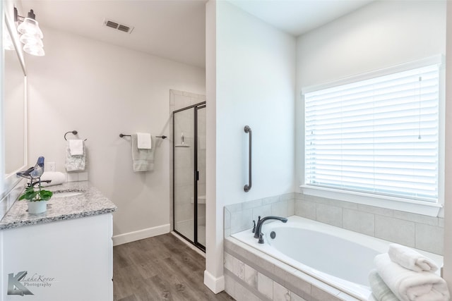 2326 Plymouth Rock Rd, Abilene, TX 79601 - full bath featuring a garden tub, a stall shower, wood finished floors, and vanity