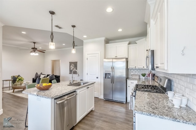 2326 Plymouth Rock Rd, Abilene, TX 79601 - kitchen with stainless steel appliances, a sink, ornamental molding, white cabinetry, and tasteful backsplash