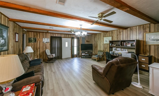 255 Barry Rd, Logansport, LA 71049 - living room with beamed ceiling, ceiling fan, wood finished floors, wood walls, and a chandelier