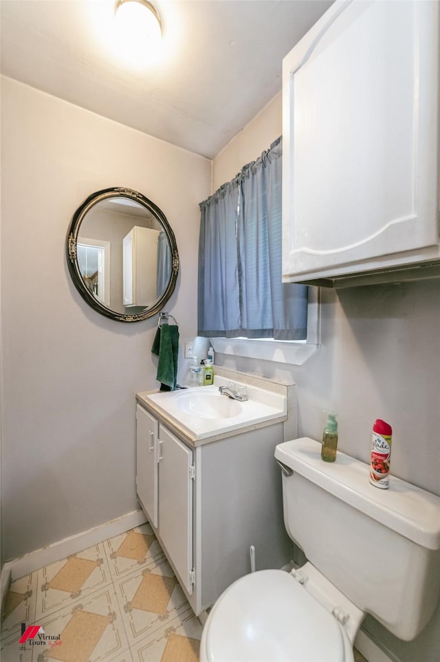 255 Barry Rd, Logansport, LA 71049 - bathroom with toilet, baseboards, vanity, and tile patterned floors