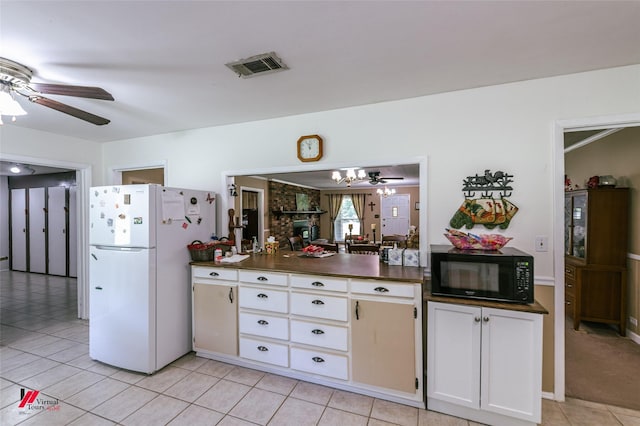 255 Barry Rd, Logansport, LA 71049 - kitchen featuring black microwave, freestanding refrigerator, a ceiling fan, dark countertops, and light tile patterned floors