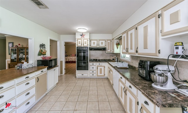 255 Barry Rd, Logansport, LA 71049 - kitchen featuring black appliances, under cabinet range hood, light tile patterned floors, and a sink
