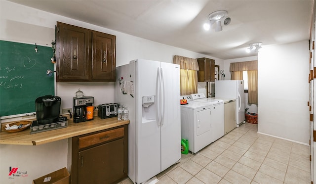 255 Barry Rd, Logansport, LA 71049 - kitchen with washer and dryer, white fridge with ice dispenser, light countertops, dark brown cabinetry, and light tile patterned floors