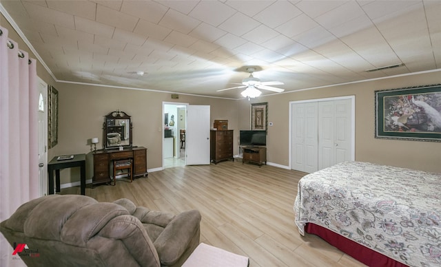 255 Barry Rd, Logansport, LA 71049 - bedroom with ornamental molding, light wood-style floors, a closet, ceiling fan, and baseboards