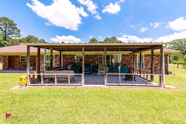 255 Barry Rd, Logansport, LA 71049 - rear view of house with a yard, a patio area, and brick siding