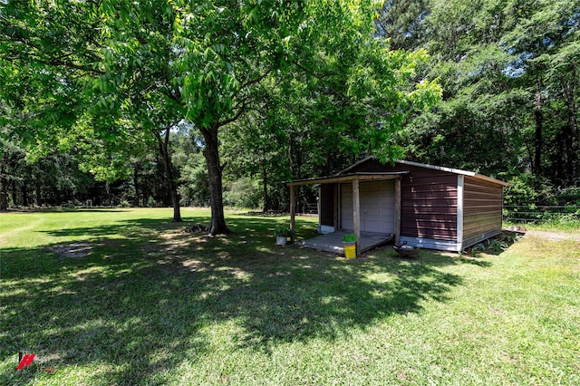 255 Barry Rd, Logansport, LA 71049 - view of green lawn with an outbuilding and a garage