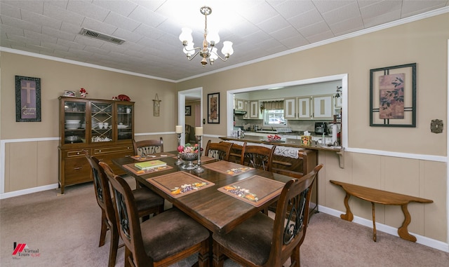 255 Barry Rd, Logansport, LA 71049 - dining area featuring a chandelier, ornamental molding, light carpet, and a wainscoted wall