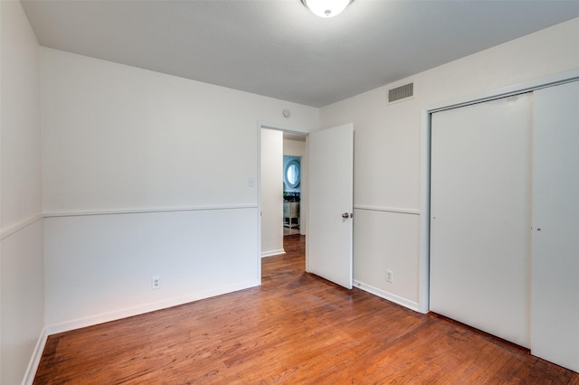 7612 Oxley Dr, Richland Hills, TX 76118 - unfurnished bedroom featuring wood finished floors, a closet, and baseboards