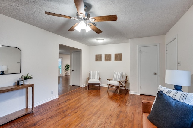 7612 Oxley Dr, Richland Hills, TX 76118 - living area with a textured ceiling, wood finished floors, ceiling fan, and baseboards