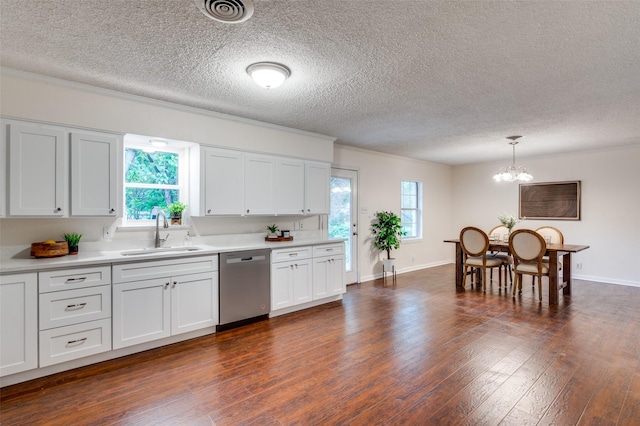 7612 Oxley Dr, Richland Hills, TX 76118 - kitchen with stainless steel dishwasher, a sink, light countertops, a chandelier, and white cabinetry
