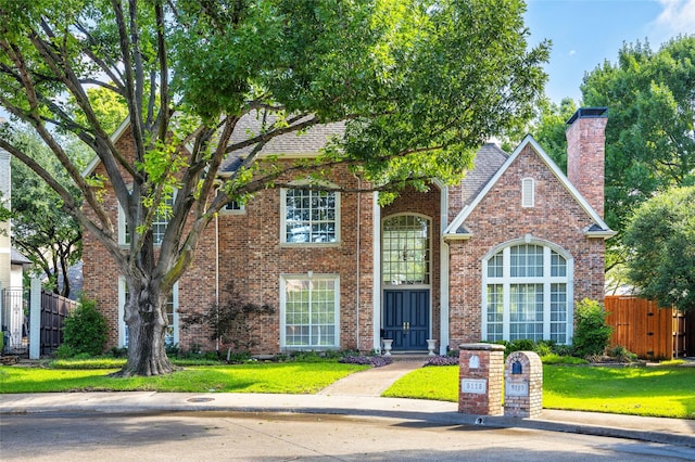 5115 Oak Tree Cir, Dallas, TX 75287 - traditional-style house featuring a chimney and brick siding