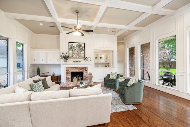 5115 Oak Tree Cir, Dallas, TX 75287 - living area featuring a decorative wall, dark wood-style floors, a brick fireplace, a ceiling fan, and coffered ceiling
