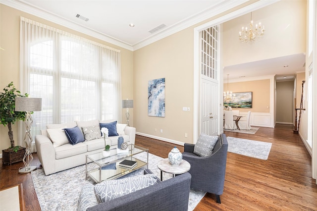 5115 Oak Tree Cir, Dallas, TX 75287 - living area featuring a chandelier, wood finished floors, ornamental molding, a towering ceiling, and baseboards