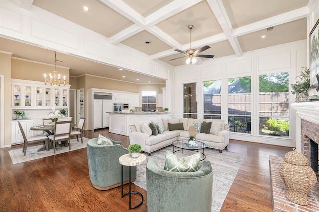 5115 Oak Tree Cir, Dallas, TX 75287 - living room with a ceiling fan, a brick fireplace, coffered ceiling, dark wood-style flooring, and a chandelier
