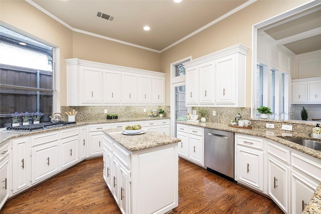 5115 Oak Tree Cir, Dallas, TX 75287 - kitchen with stainless steel appliances, decorative backsplash, white cabinetry, crown molding, and recessed lighting