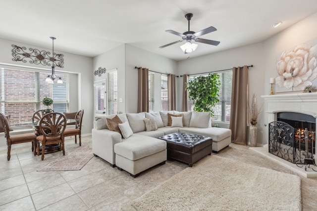 10420 Old Eagle River Ln, Mckinney, TX 75072 - living room featuring light tile patterned flooring, a chandelier, ceiling fan, and a lit fireplace