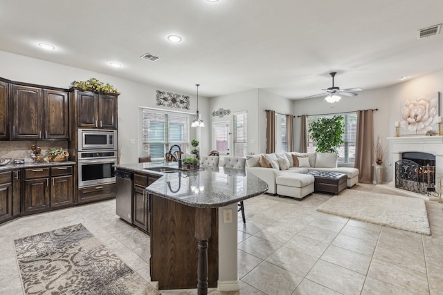 10420 Old Eagle River Ln, Mckinney, TX 75072 - kitchen with stainless steel appliances, a sink, ceiling fan, healthy amount of natural light, and recessed lighting
