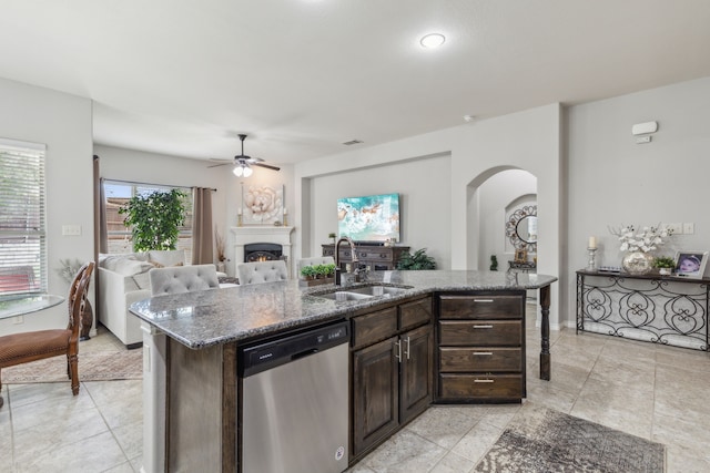 10420 Old Eagle River Ln, Mckinney, TX 75072 - kitchen with dishwasher, a sink, a ceiling fan, arched walkways, and dark brown cabinetry