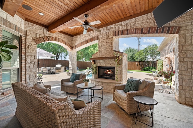 840 Falcon Ln, Coppell, TX 75019 - fenced backyard featuring ceiling fan, an outdoor living space with a fireplace, and a patio