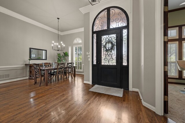 840 Falcon Ln, Coppell, TX 75019 - foyer featuring a chandelier, plenty of natural light, dark wood-type flooring, crown molding, and a high ceiling