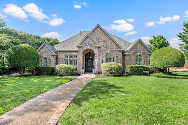 840 Falcon Ln, Coppell, TX 75019 - view of front of house with brick siding, a front lawn, and a shingled roof