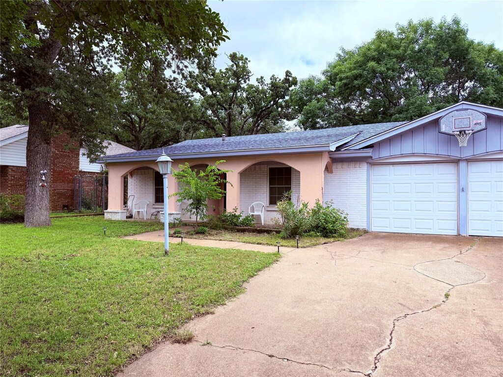 2906 SE 6th St, Mineral Wells, TX 76067 - ranch-style home with covered porch, brick siding, a front lawn, driveway, and an attached garage