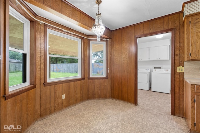 4404 Curtis Loop, Bossier City, LA 71112 - unfurnished dining area with wooden walls, washer and clothes dryer, and a chandelier