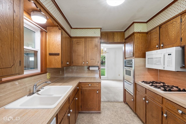 4404 Curtis Loop, Bossier City, LA 71112 - kitchen featuring white appliances, a warming drawer, brown cabinets, and ornamental molding