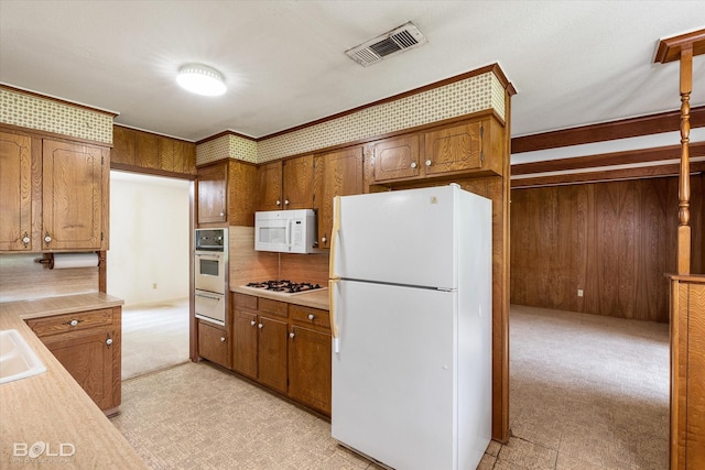 4404 Curtis Loop, Bossier City, LA 71112 - kitchen with white appliances, a warming drawer, light countertops, decorative backsplash, and brown cabinets