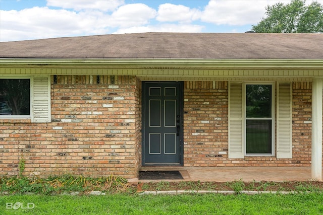 4404 Curtis Loop, Bossier City, LA 71112 - entrance to property with brick siding, a shingled roof, and covered porch