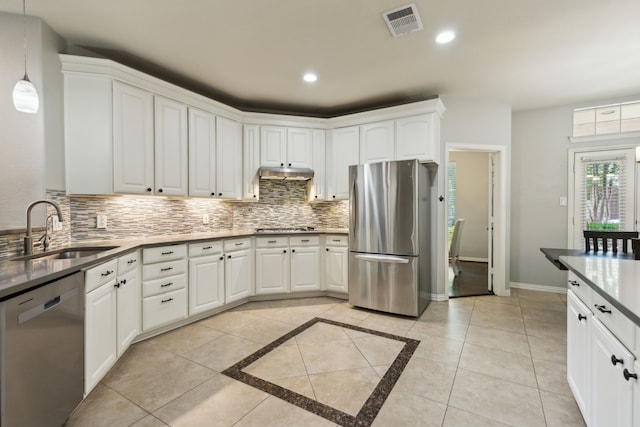 4104 Navarro Way, Frisco, TX 75034 - kitchen with appliances with stainless steel finishes, a sink, decorative backsplash, white cabinets, and recessed lighting