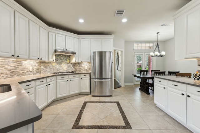 4104 Navarro Way, Frisco, TX 75034 - kitchen featuring stainless steel appliances, under cabinet range hood, decorative backsplash, baseboards, and white cabinets