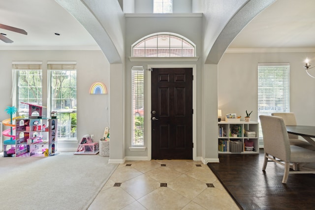 4104 Navarro Way, Frisco, TX 75034 - tiled foyer featuring arched walkways, plenty of natural light, ceiling fan, and crown molding